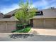 Inviting townhouse featuring a well-manicured lawn and attached garages at 1470 S Quebec Way # 46, Denver, CO 80231
