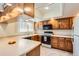 Well-lit kitchen with wood cabinets, modern appliances, and ample counter space, offering a functional design at 1470 S Quebec Way # 46, Denver, CO 80231