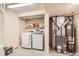 Laundry room with modern washer and dryer, shelving, and adjacent furnace room at 1470 S Quebec Way # 46, Denver, CO 80231