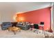 Spacious living room with a large window, a desk, and a comfortable seating area at 1470 S Quebec Way # 46, Denver, CO 80231