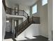 Bright entryway featuring a staircase with dark wood railings, creating a grand and welcoming atmosphere at 16654 W 93Rd Way, Arvada, CO 80007