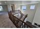 Upper-level loft with wood railing overlooking the entryway, offering views of windows and ample natural light at 16654 W 93Rd Way, Arvada, CO 80007