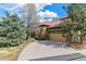 Charming home featuring a brick driveway, attached garage, and lush landscaping at 7850 Vallagio Ln, Englewood, CO 80112