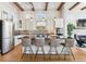 Modern kitchen with a large island, stainless steel appliances, and decorative backsplash at 7850 Vallagio Ln, Englewood, CO 80112