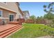 Backyard with a wooden deck, grass lawn, and sliding door access at 24416 E Powers Ave, Aurora, CO 80016