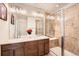 Bathroom featuring a double vanity, tiled walk-in shower, and modern lighting at 24416 E Powers Ave, Aurora, CO 80016