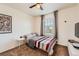 Cozy bedroom features a ceiling fan and a window letting in natural light at 24416 E Powers Ave, Aurora, CO 80016