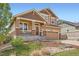 Charming two-story home showcasing a covered front porch, stone accents, and a well-maintained front yard at 24416 E Powers Ave, Aurora, CO 80016