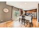 Well-lit kitchen with stainless steel appliances, wood cabinetry, and an adjacent dining area at 24416 E Powers Ave, Aurora, CO 80016