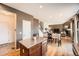 Open concept kitchen and dining area with stainless steel appliances and hardwood floors at 24416 E Powers Ave, Aurora, CO 80016