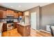 Kitchen with stainless steel appliances, wood cabinetry, central island, and hardwood floors at 24416 E Powers Ave, Aurora, CO 80016