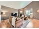 Bright living room features a fireplace, neutral walls, and large window providing lots of natural light at 24416 E Powers Ave, Aurora, CO 80016