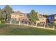 Large backyard featuring a covered patio, lush lawn, and privacy fencing at 4121 S Allison St, Denver, CO 80235