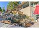 Backyard water feature with decorative rocks, plants, and statuary at 4121 S Allison St, Denver, CO 80235
