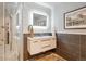 Modern bathroom featuring sleek vanity with backlit mirror and tiled walls at 4121 S Allison St, Denver, CO 80235