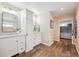 Bright bathroom featuring double vanity, granite countertops, wood floors and storage at 4121 S Allison St, Denver, CO 80235