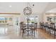 Eat-in dining area features a modern chandelier, breakfast bar, and large picture window with mountain views at 4121 S Allison St, Denver, CO 80235