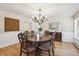 Formal dining room with hardwood floors, a decorative chandelier, and custom wall details for an elegant dining experience at 4121 S Allison St, Denver, CO 80235