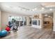 Finished basement exercise room featuring a fireplace and sliding glass doors to the outside at 4121 S Allison St, Denver, CO 80235