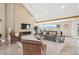 Bright living room features a vaulted ceiling, fireplace, and expansive windows with mountain views at 4121 S Allison St, Denver, CO 80235