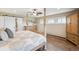 Bright main bedroom boasts a four-poster bed frame and an attached ensuite bathroom at 4121 S Allison St, Denver, CO 80235