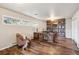 Office with hardwood floors, custom bookcase, and desk with large picture window at 4121 S Allison St, Denver, CO 80235