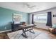 Bright home office features modern desk, area rug, scenic view, and accent wall at 4121 S Allison St, Denver, CO 80235