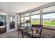 Sunroom features multiple windows with views of a lake and golf course and brick walls at 4121 S Allison St, Denver, CO 80235