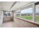 Bright sunroom overlooking golf course and lake with brick walls and tile floor at 4121 S Allison St, Denver, CO 80235