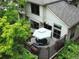 Exterior view of a house, surrounded by lush greenery, featuring a deck with outdoor seating at 912 S Galena St, Aurora, CO 80247