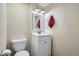 Compact bathroom with modern toilet and vanity, paired with updated lighting at 912 S Galena St, Aurora, CO 80247