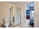 Bathroom featuring a gold-framed shower, toilet, and a view to a bedroom with a ceiling fan and dresser at 912 S Galena St, Aurora, CO 80247