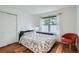 Charming bedroom featuring hardwood floors, natural light, and a stylish accent chair at 912 S Galena St, Aurora, CO 80247