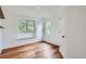 Bright bedroom with hardwood floors, two windows, and closet door at 912 S Galena St, Aurora, CO 80247