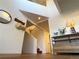 Bright entryway with hardwood floors, modern shelving, and stairs leading to the upper level at 912 S Galena St, Aurora, CO 80247