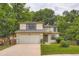 Traditional two-story home featuring a well-maintained lawn and a two-car garage at 912 S Galena St, Aurora, CO 80247