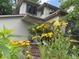 Charming home exterior accented by vibrant flowers and lush greenery, creating a welcoming facade at 912 S Galena St, Aurora, CO 80247