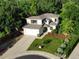 Aerial view of a two-story home with a well-manicured lawn, mature trees, and an attached two-car garage at 912 S Galena St, Aurora, CO 80247