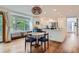 View of a kitchen with stainless steel appliances, blue cabinets, white walls, and a round wooden dining table at 912 S Galena St, Aurora, CO 80247
