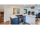 View of kitchen with stainless steel oven and gas cooktop, as well as view to living area with fireplace at 912 S Galena St, Aurora, CO 80247