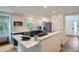 Well-lit kitchen with stainless steel appliances, white cabinets, and an adjacent dining area at 912 S Galena St, Aurora, CO 80247