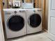 Modern, white Whirlpool washer and dryer set, with white woven basket on top in the laundry room at 912 S Galena St, Aurora, CO 80247