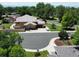 Aerial view of a home showing a large yard with a patio, mature trees, and an attached garage at 912 S Galena St, Aurora, CO 80247