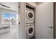 Convenient laundry closet with a stacked washer and dryer unit at 3520 W Conejos Pl # 10, Denver, CO 80204