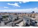 Panoramic view from rooftop deck showcasing outdoor living spaces with seating, grills, and stunning city and mountain views at 3520 W Conejos Pl # 10, Denver, CO 80204