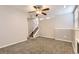 Basement featuring neutral walls, carpet, fireplace, light fixture and stairs at 8432 S Upham Way, Littleton, CO 80128
