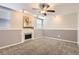 Basement featuring neutral walls, carpet, fireplace and light fixture at 8432 S Upham Way, Littleton, CO 80128
