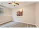 Cozy bedroom featuring neutral carpet, a ceiling fan, and a large floral art print at 8432 S Upham Way, Littleton, CO 80128