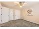 A cozy bedroom with neutral walls, a ceiling fan and closet space at 8432 S Upham Way, Littleton, CO 80128