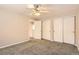Bedroom featuring neutral walls, plush carpet and ample closet space at 8432 S Upham Way, Littleton, CO 80128